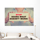Businesswoman hands holding sign Stop Doing What Doesn't Work Wall Decal