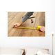 Carpenter worker installing laminate flooring in the room Wall Decal