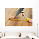 Carpenter worker installing laminate flooring in the room Wall Decal