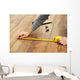 Carpenter worker installing laminate flooring in the room Wall Decal