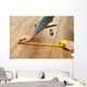 Carpenter worker installing laminate flooring in the room Wall Decal