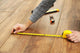 Carpenter worker installing laminate flooring in the room Wall Decal