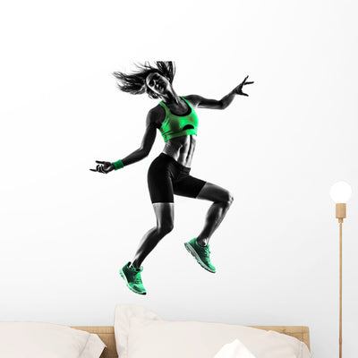 Jumping Fitness Woman Wall Decal shown on a wall