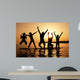 Silhouette of kids jumping on the beach Wall Decal