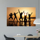 Silhouette of kids jumping on the beach Wall Decal