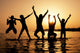 Silhouette of kids jumping on the beach Wall Decal