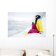 snowboarder woman sitting on snow mountain slope Wall Decal