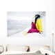 snowboarder woman sitting on snow mountain slope Wall Decal