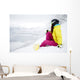 snowboarder woman sitting on snow mountain slope Wall Decal