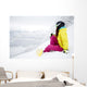 snowboarder woman sitting on snow mountain slope Wall Decal