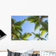 Looking up on coconut palm trees over blue sky background Wall Decal