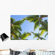Looking up on coconut palm trees over blue sky background Wall Decal