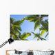 Looking up on coconut palm trees over blue sky background Wall Decal