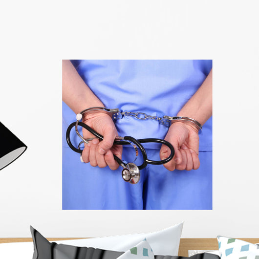 Doctor with stethoscope in handcuffs Wall Decal