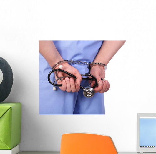 Doctor with stethoscope in handcuffs isolated on white Wall Decal