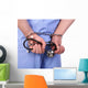 Doctor with stethoscope in handcuffs isolated on white Wall Decal
