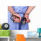 Doctor with stethoscope in handcuffs isolated on white Wall Decal