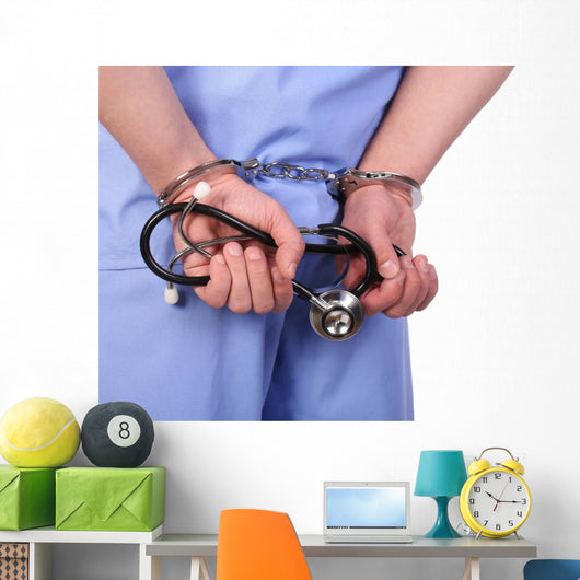 Doctor with stethoscope in handcuffs isolated on white Wall Decal