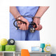 Doctor with stethoscope in handcuffs isolated on white Wall Decal
