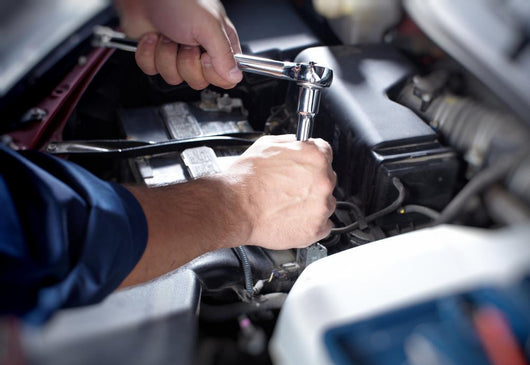 Mechanic working in auto repair garage Wall Decal