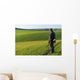 Gamekeeper walks over field. Wall Decal