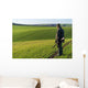 Gamekeeper walks over field. Wall Decal