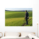 Gamekeeper walks over field. Wall Decal