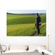 Gamekeeper walks over field. Wall Decal