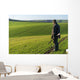 Gamekeeper walks over field. Wall Decal