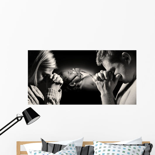 Parents pray for the health of seriously ill daughter. Wall Decal