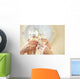Glasses of champagne in female hands on a party Wall Decal