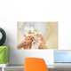 Glasses of champagne in female hands on a party Wall Decal