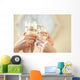 Glasses of champagne in female hands on a party Wall Decal