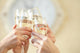 Glasses of champagne in female hands on a party Wall Decal