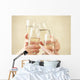 Glasses of champagne in female hands on a party Wall Decal