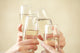 Glasses of champagne in female hands on a party Wall Decal