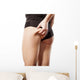 woman checking her bottom with pinching Wall Decal