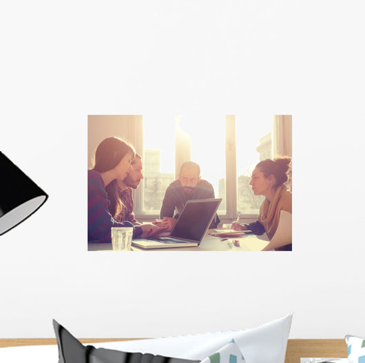 Young group of people/architects discussing business plans. Wall Decal