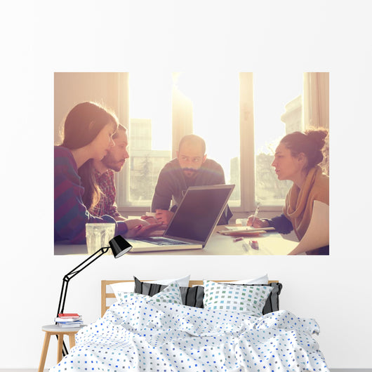 Young group of people/architects discussing business plans. Wall Decal