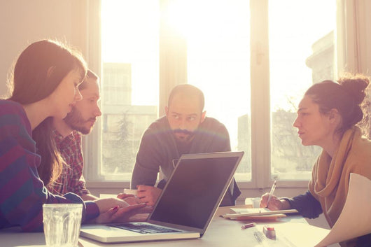 Young group of people/architects discussing business plans. Wall Decal