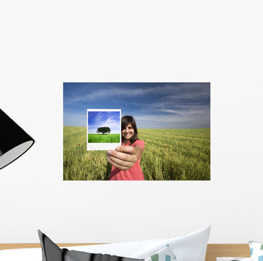 young woman smiling holding single polaroid film strip Wall Decal