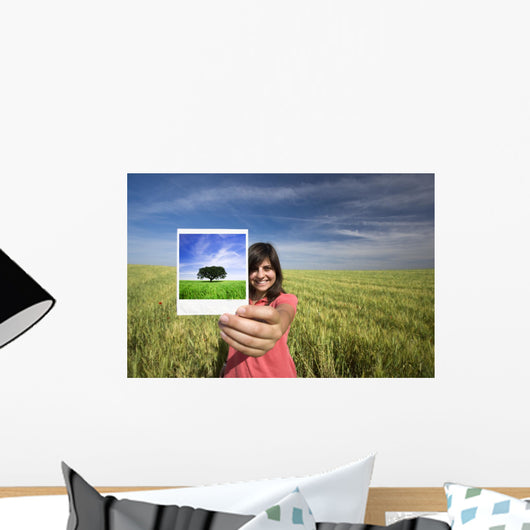 young woman smiling holding single polaroid film strip Wall Decal
