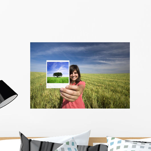 young woman smiling holding single polaroid film strip Wall Decal