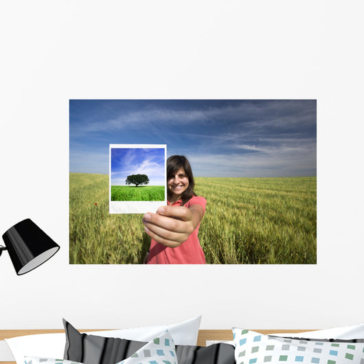 young woman smiling holding single polaroid film strip Wall Decal