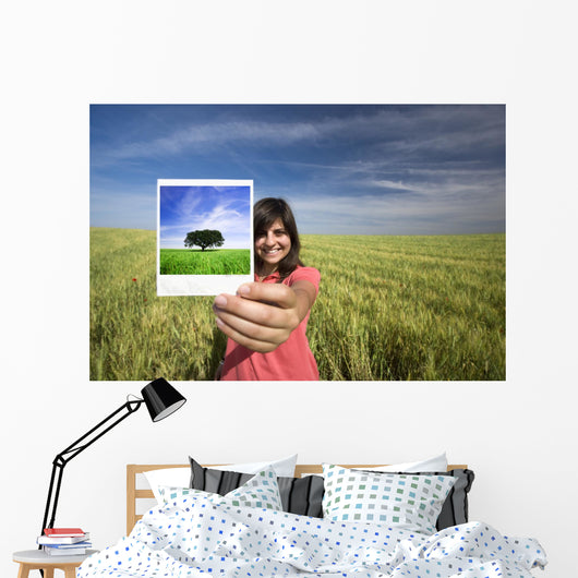 young woman smiling holding single polaroid film strip Wall Decal