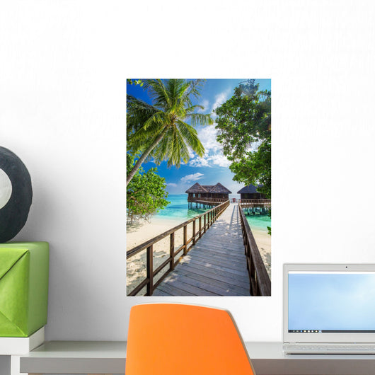 Bridge leading to overwater bungalow in blue lagoon Wall Decal