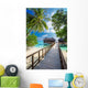 Bridge leading to overwater bungalow in blue lagoon Wall Decal