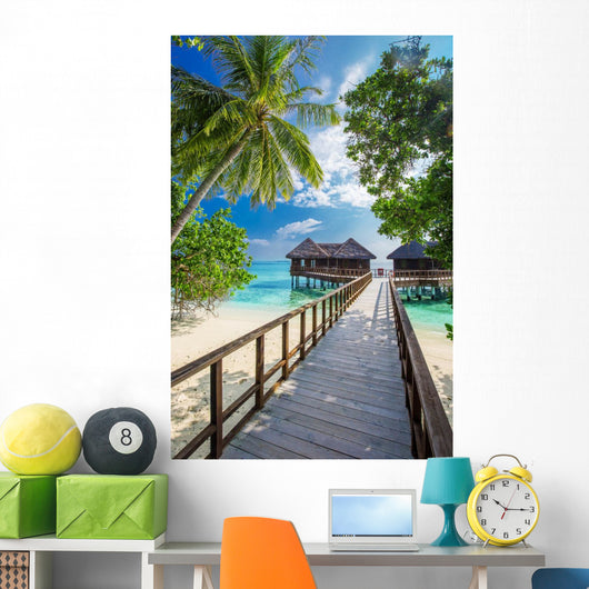 Bridge leading to overwater bungalow in blue lagoon Wall Decal