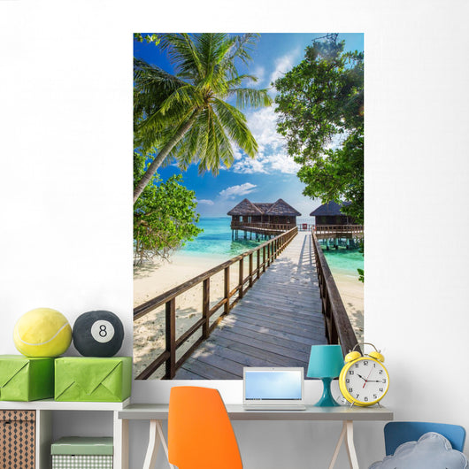 Bridge leading to overwater bungalow in blue lagoon Wall Decal