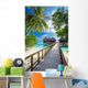 Bridge leading to overwater bungalow in blue lagoon Wall Decal